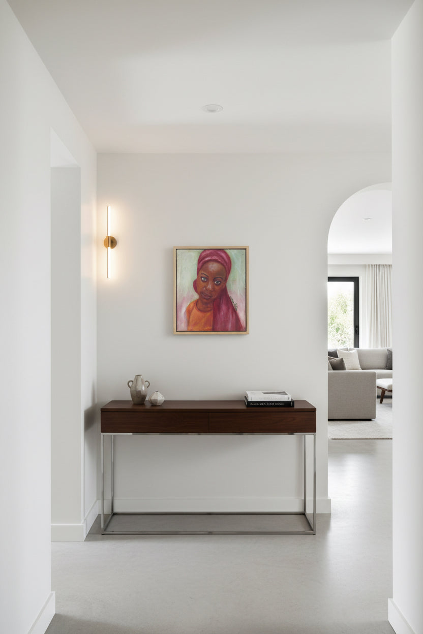 Little Amina" by Bibianna African Art Collective is a hand-signed painting of a woman with a calm expression, in a pink headscarf and orange top, set against green with objects and shelves. Includes certificate of authenticity.