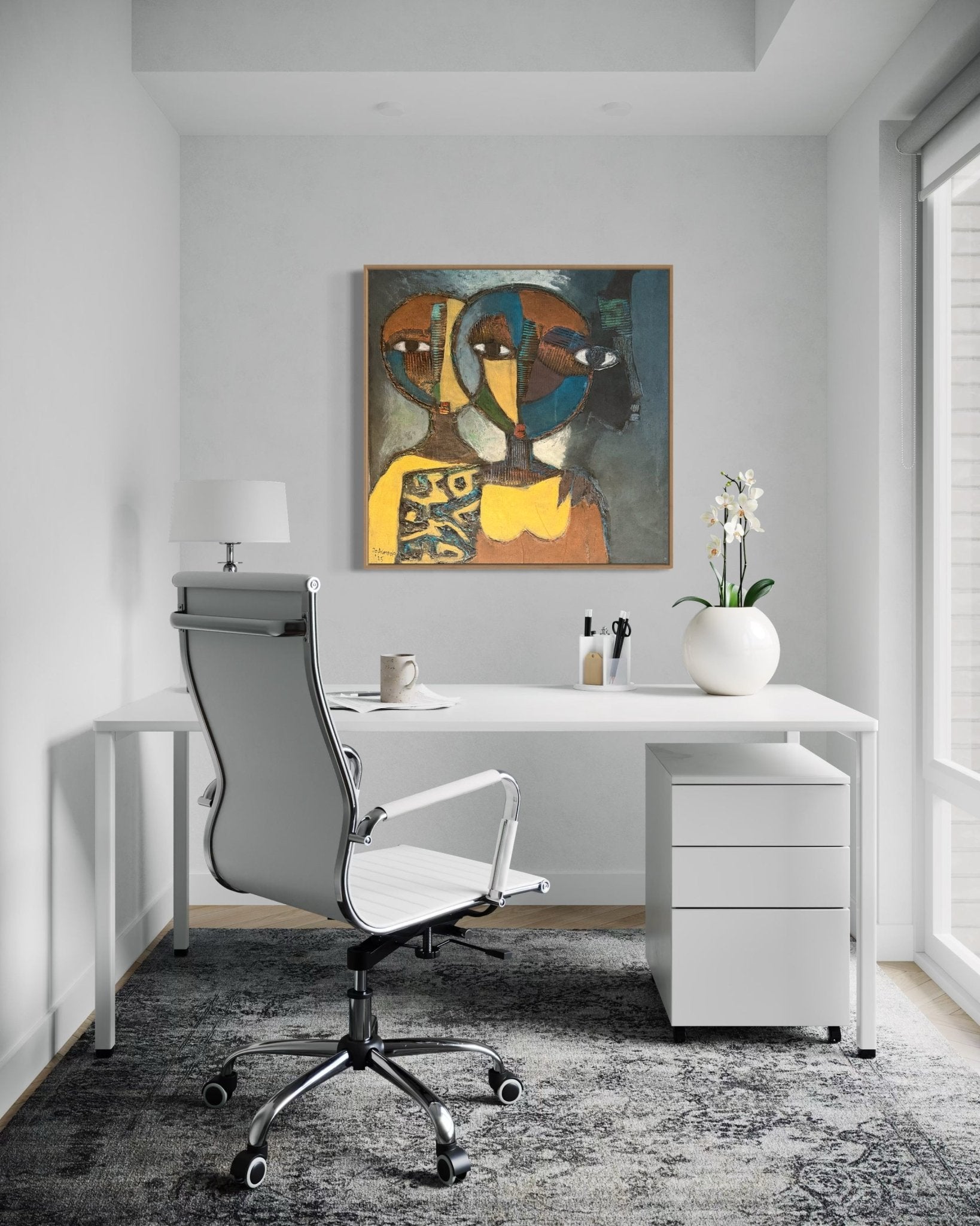 A modern, minimal home office features a white desk, chair, and drawers. On the desk are a lamp, mug, and potted orchid. Above hangs "Faces in the heart" by J.O. Aransiola—a hand-signed painting with certificate of authenticity.