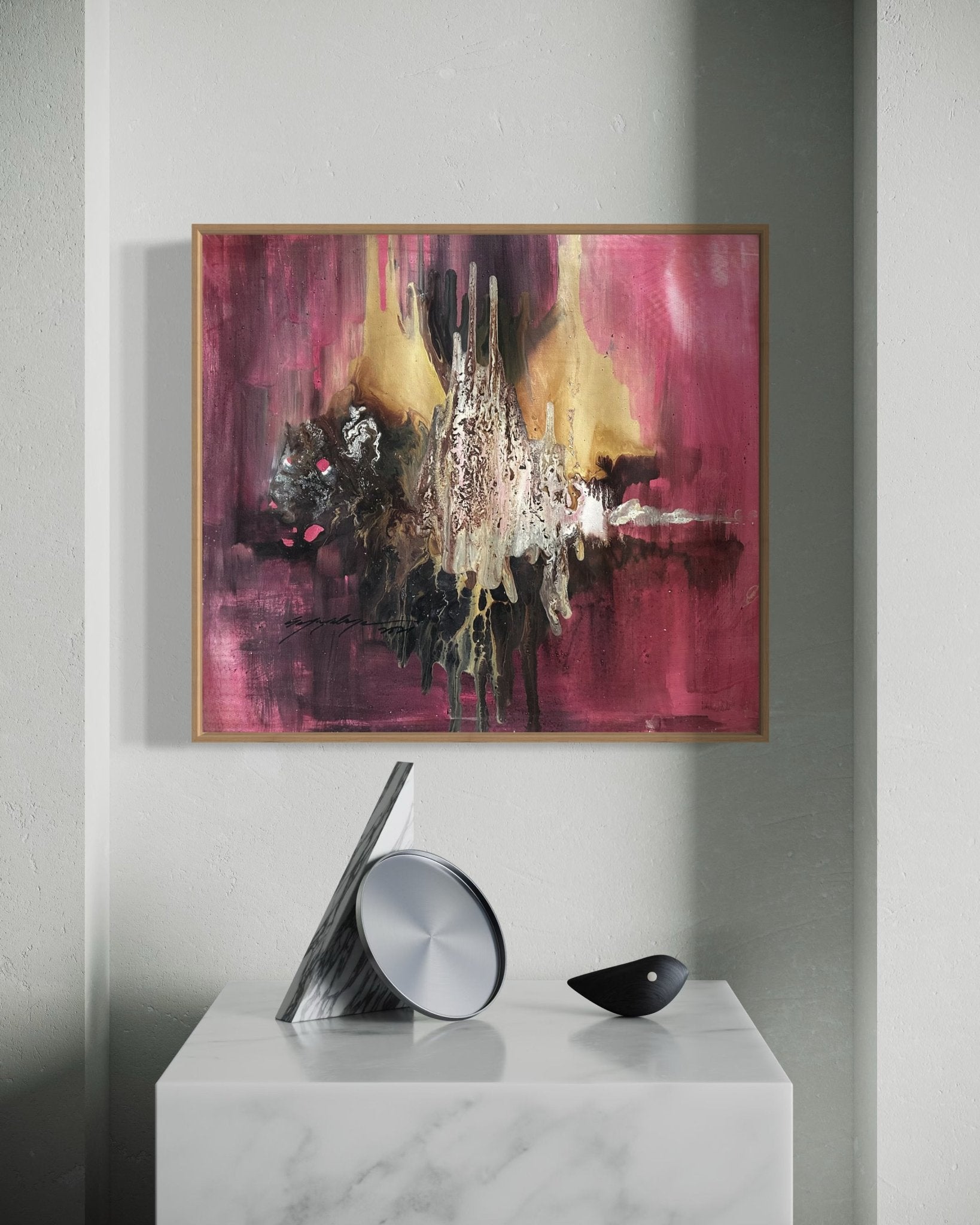 ‘Majority’ by Soji O is an abstract oil on canvas with bold black, brown, gold, and white splashes on a red/pink background. Hand-signed, framed, and includes a certificate of authenticity. Shown above a white marble table with modern décor.