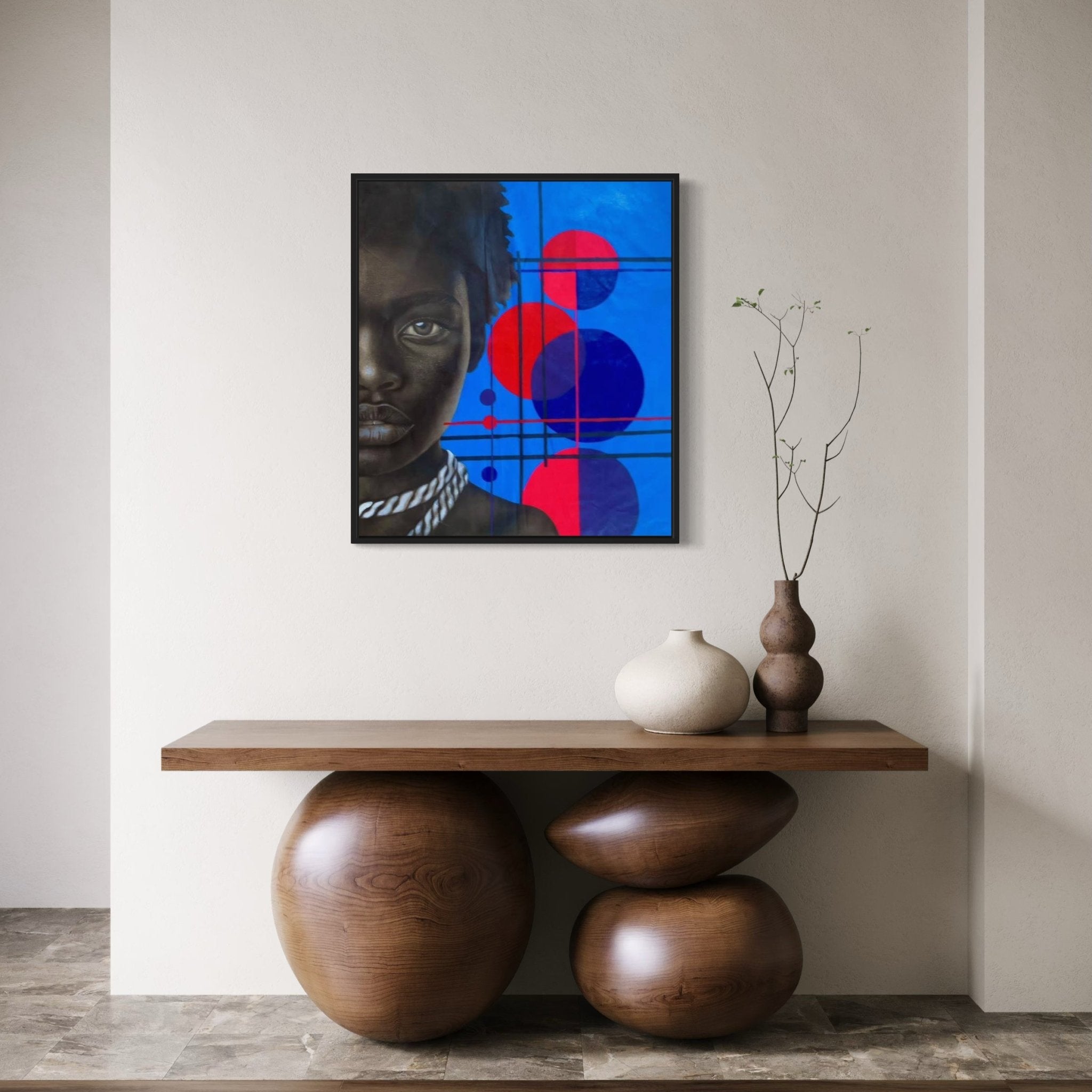 A minimal interior features a wooden console with sculptural bases, three ceramic vases, and 'Mindset'—a hand-signed Taiwo John Afuye painting with a certificate of authenticity—showing a geometric red and blue partial portrait.