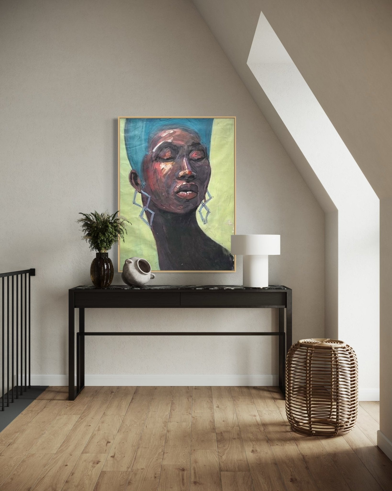 A modern interior showcases Odofin Ernesto’s "My Choice" Strong Black Female Abstract Portrait above a black console styled with a vase, sculpture, and white lamp, while a wicker basket rests on the wooden floor nearby.