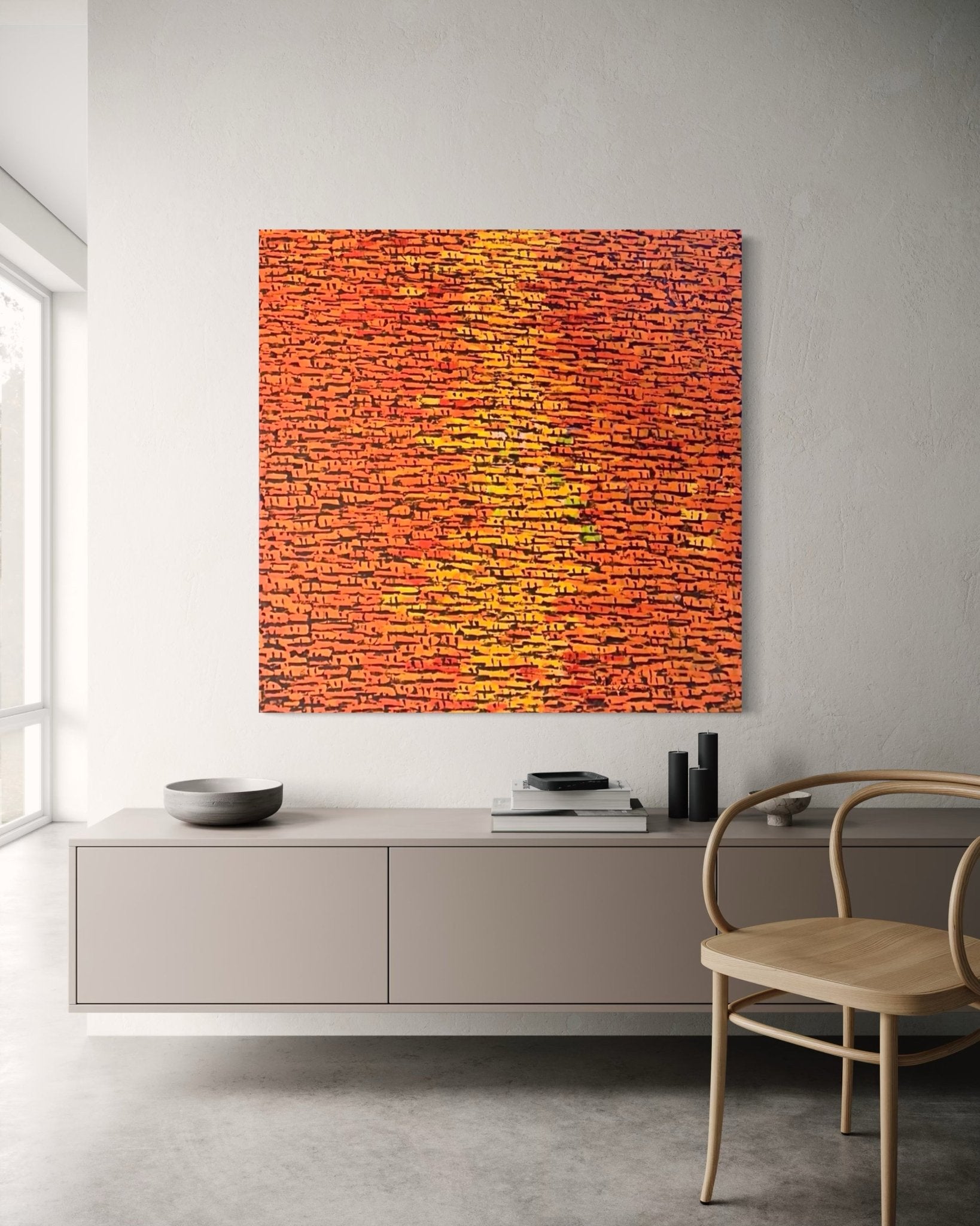 A modern living space with a light sideboard and wooden chair features "Rooftops" Series, a vibrant orange-red abstract acrylic on canvas by Akhile Ehiforia, hand-signed and brick-patterned, with certificate of authenticity included.