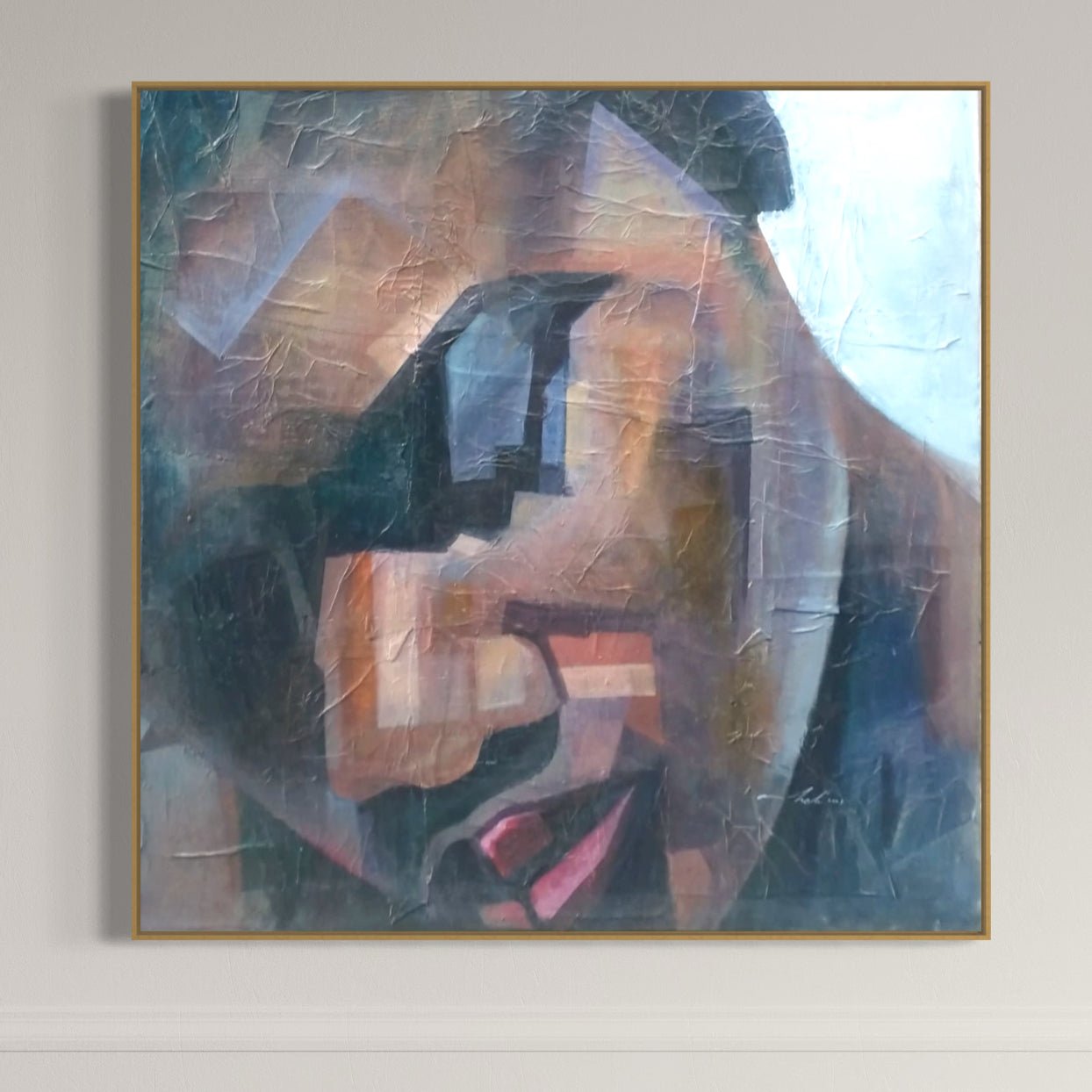 Peace" Textured Painting by Christopher Ankeli features a cubist face in muted acrylics on canvas, with geometric forms and rich shadows, beautifully framed in gold and displayed on a light wall.