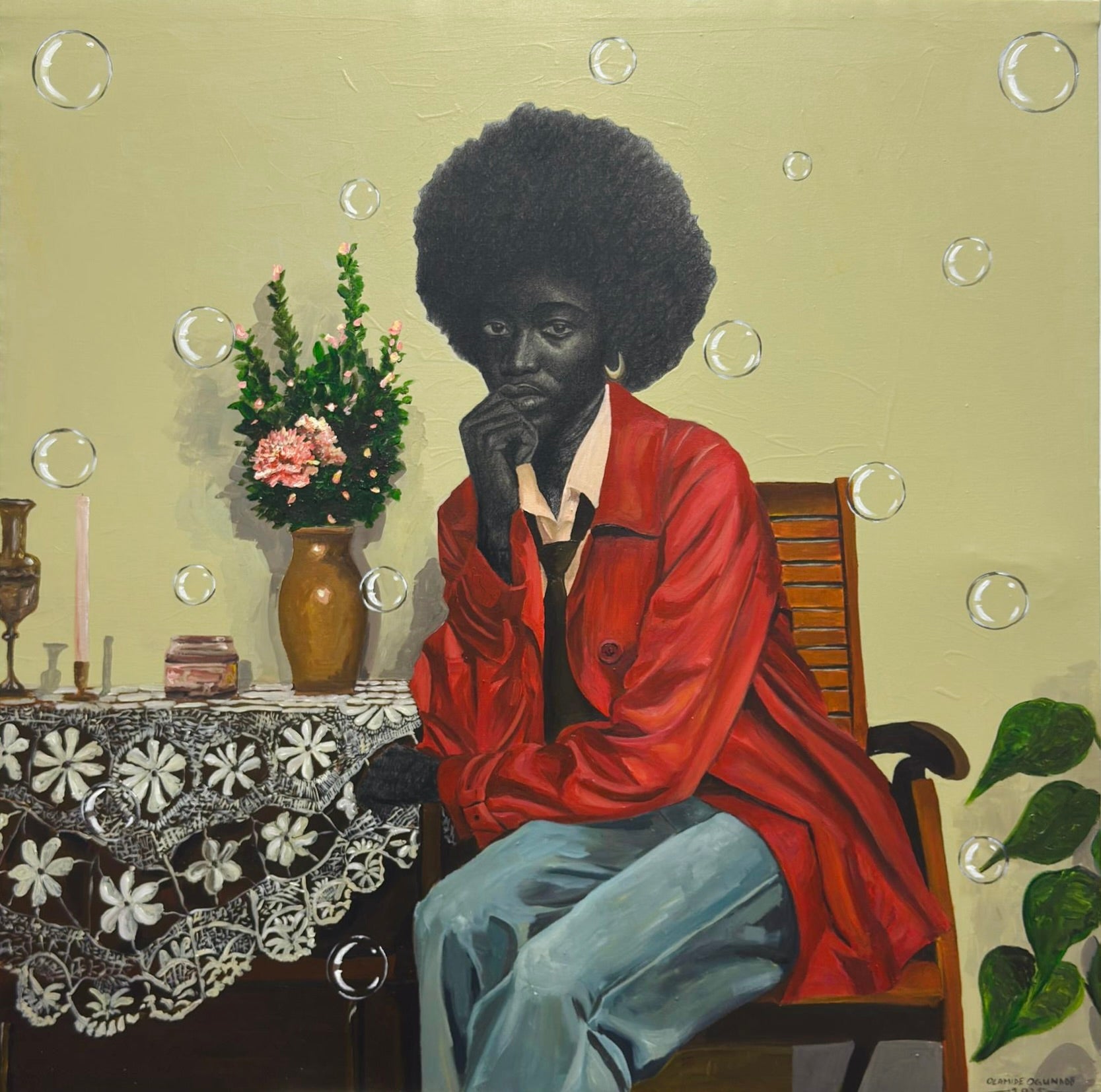 In "The Presence Of Silence" by Olamide Ogunade, a person with an afro in a red jacket and blue jeans sits on a wooden chair, chin in hand. A lace-covered table, floral vase, and background bubbles evoke contemporary African art.